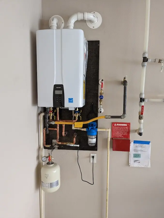 Professional plumber installing copper piping in a Silver Lake home